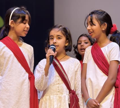 A student speaking to the room while classmates listen