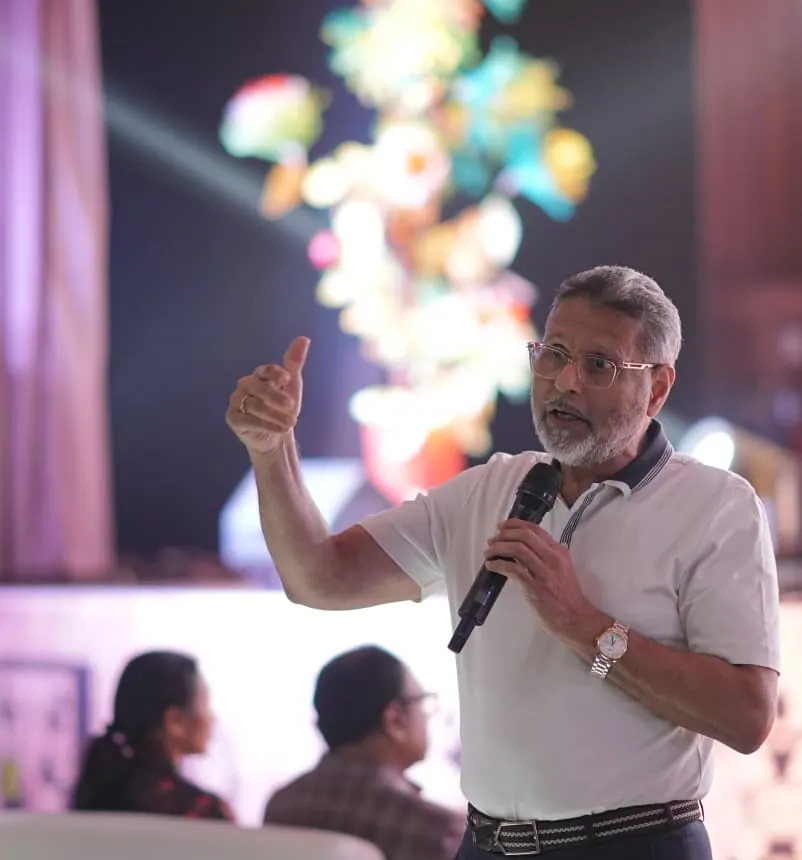 Dr. Chenraj Roychand, Founder Chairman of the Jain Group, speaking to an audience