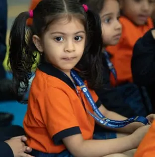 Young student in school uniform in class