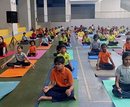 Students on mats during a whole-school mindfulness session